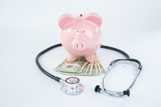 Pink Piggy Bank with Sethoscope and Money