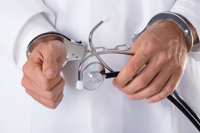 Arrested Doctor's Hand With Stethoscope